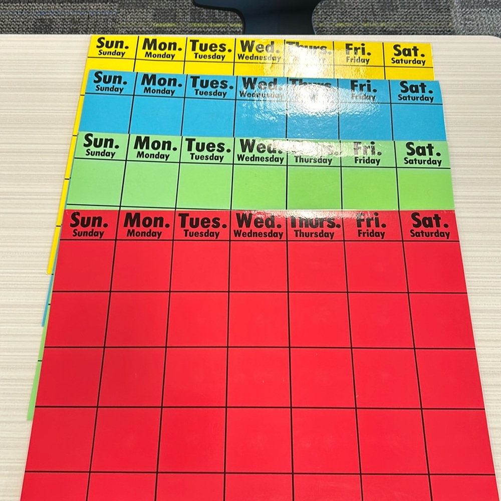 4 Colored Calendars! Laminated and in good condition still!